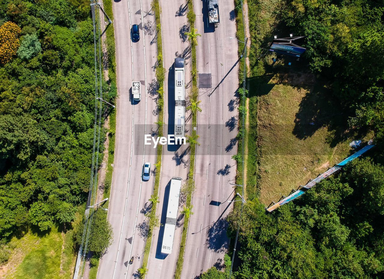 Aerial view of vehicles on highway amidst trees