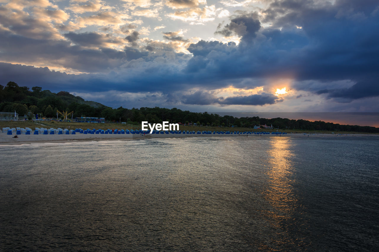 Scenic view of beach against sky during sunset