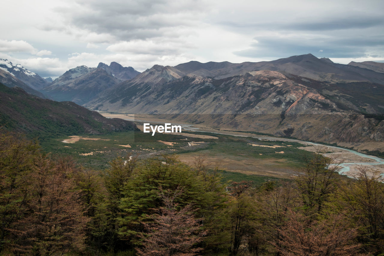 Scenic view of valley mountains against sky in autumn