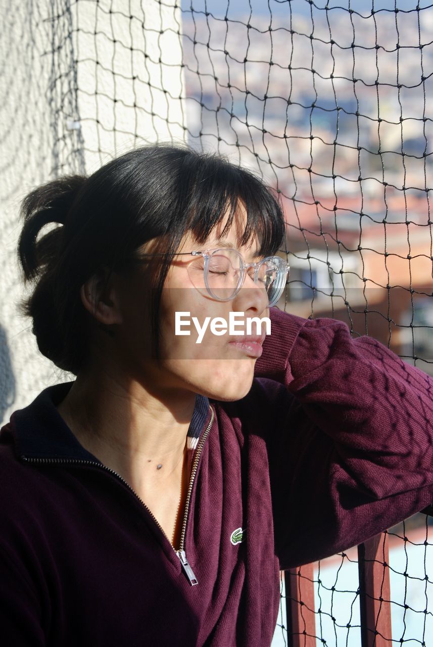 Close-up of young woman looking away