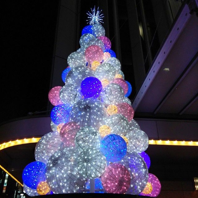 LOW ANGLE VIEW OF ILLUMINATED CHRISTMAS TREE