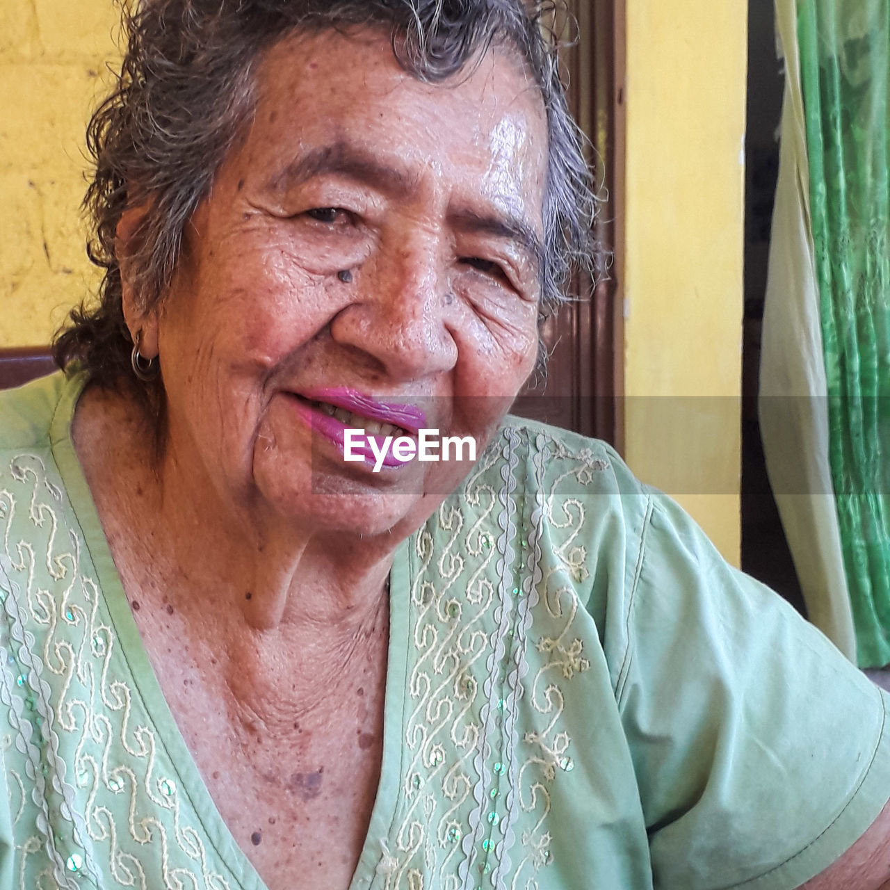 Portrait of smiling senior woman at home