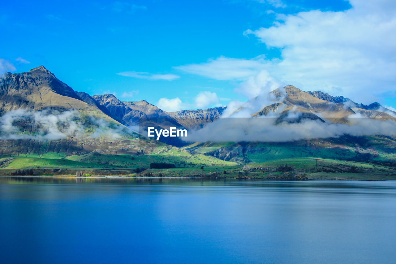 Scenic view of lake and mountains against sky