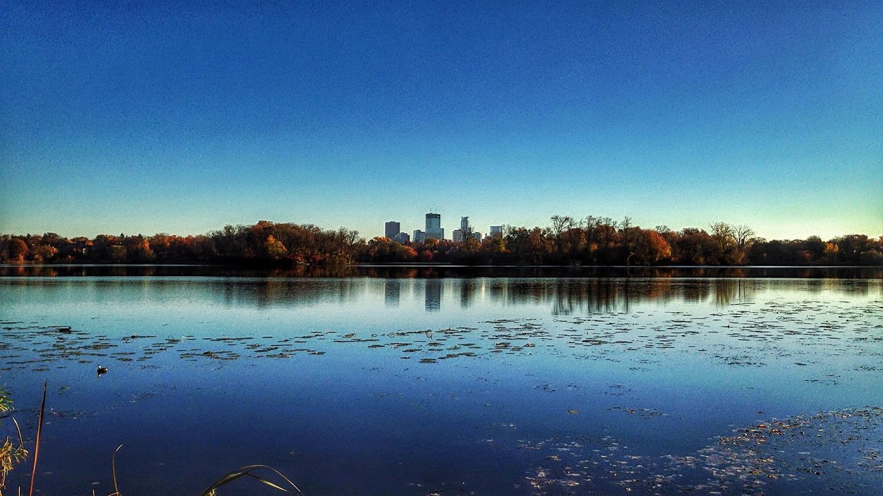 SCENIC VIEW OF CALM LAKE AT SUNSET