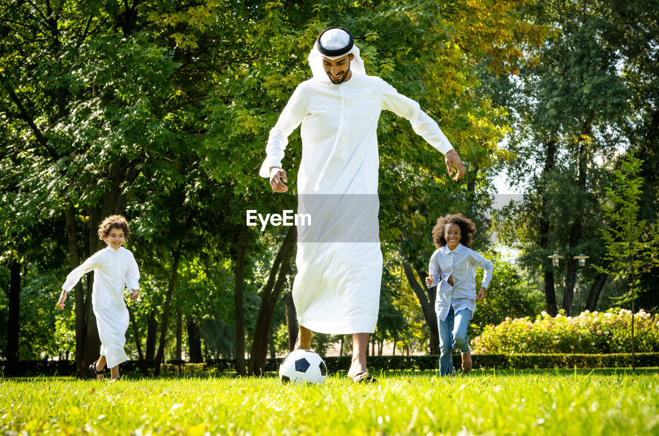 Full length of boy with ball in park