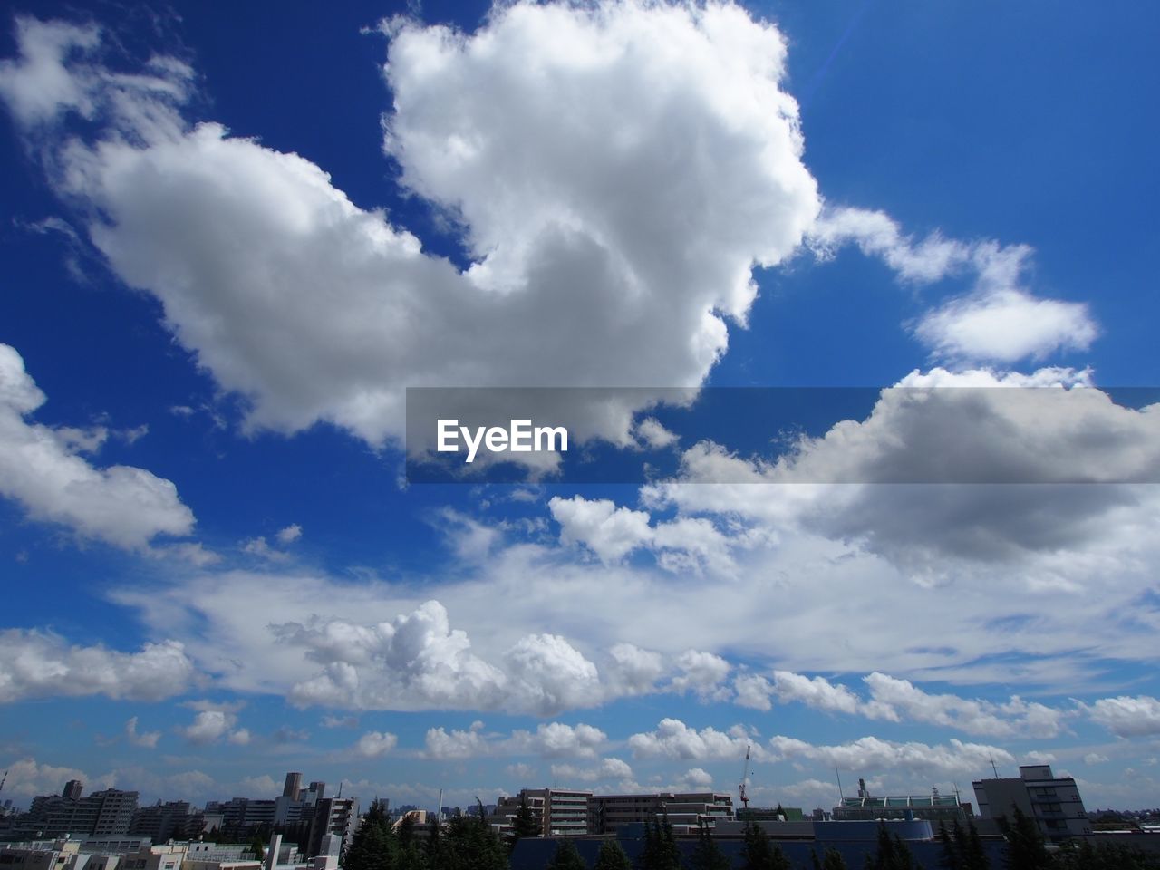 Low angle view of cityscape against blue sky