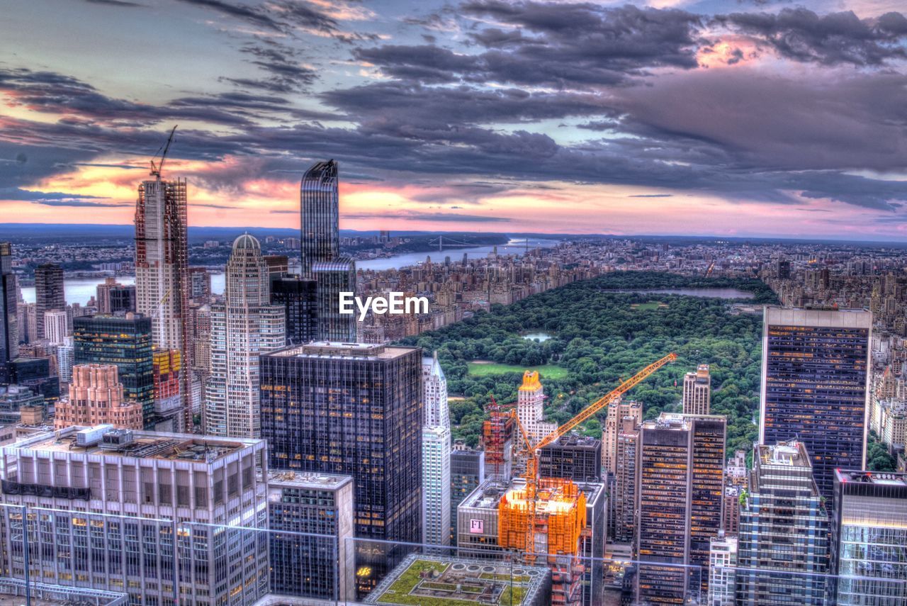 AERIAL VIEW OF CITY AGAINST CLOUDY SKY