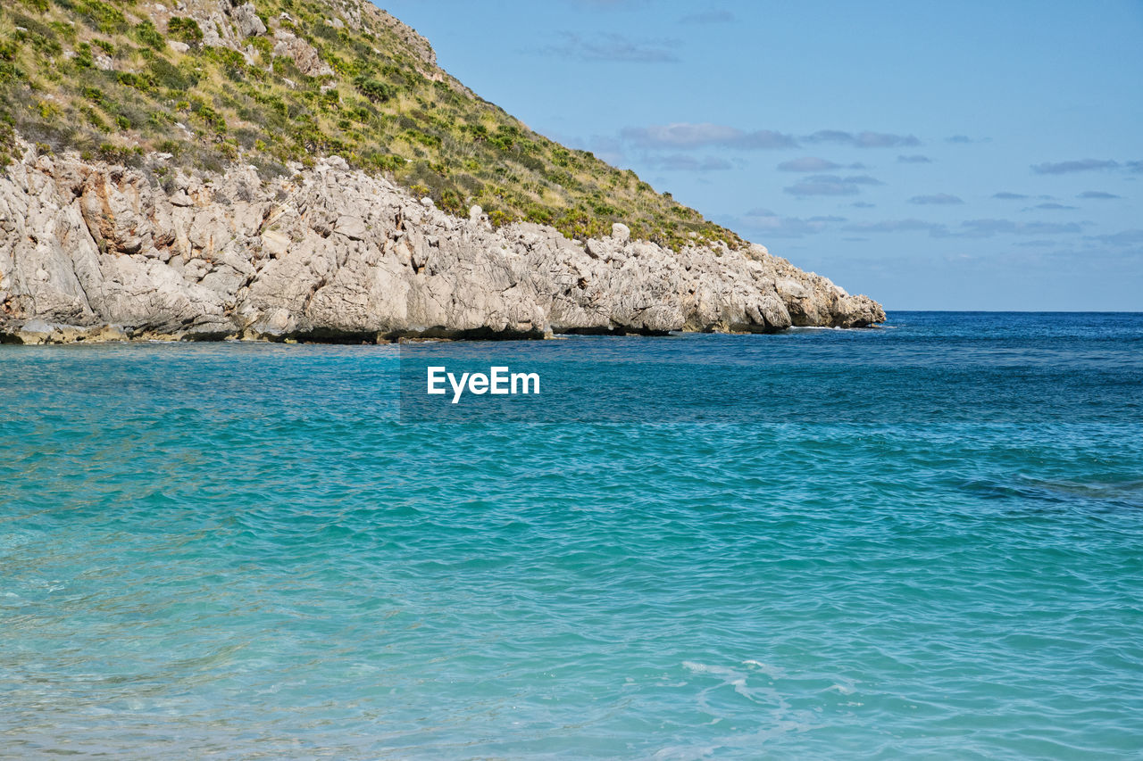 Scenic view of sea against rocks