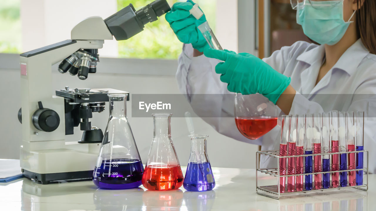 Close-up of scientist examining chemical in laboratory