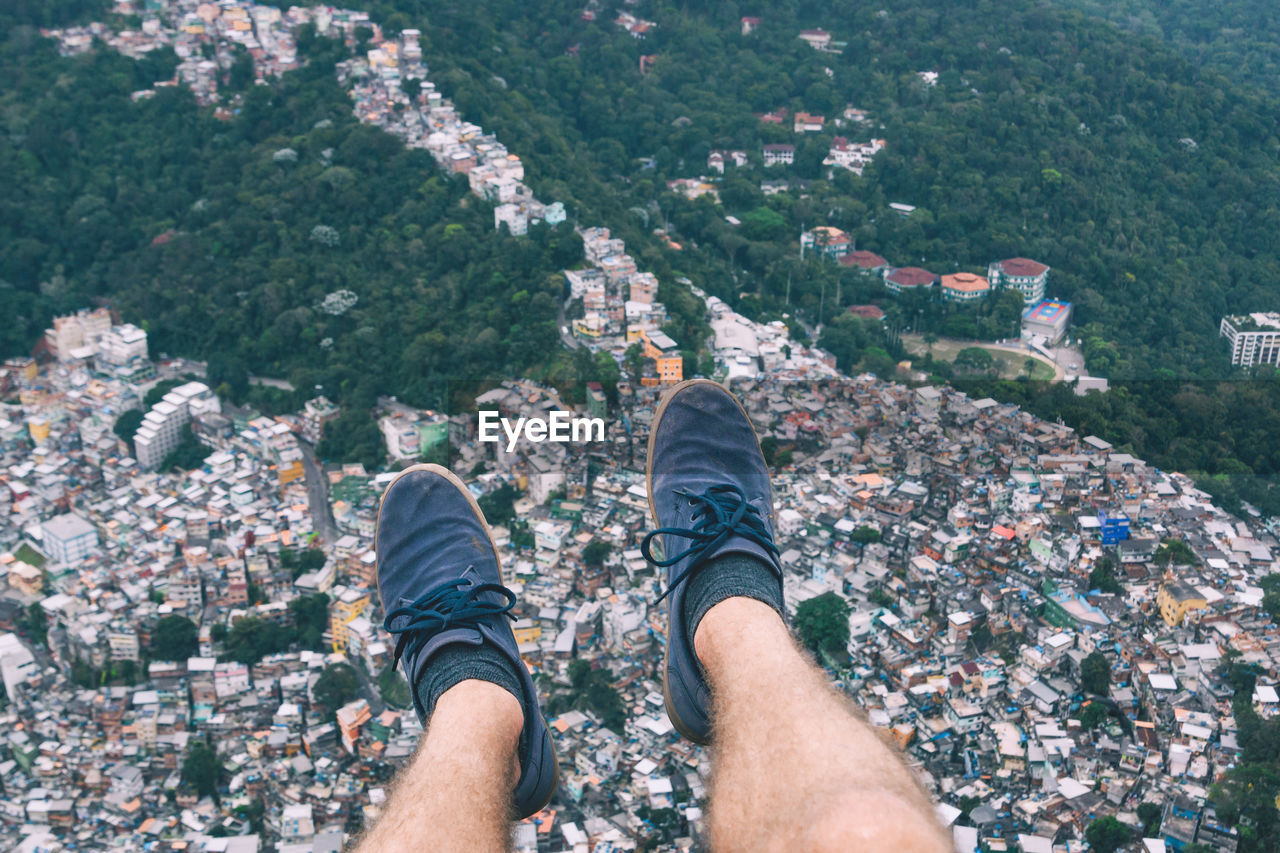 Low section of man's legs above city