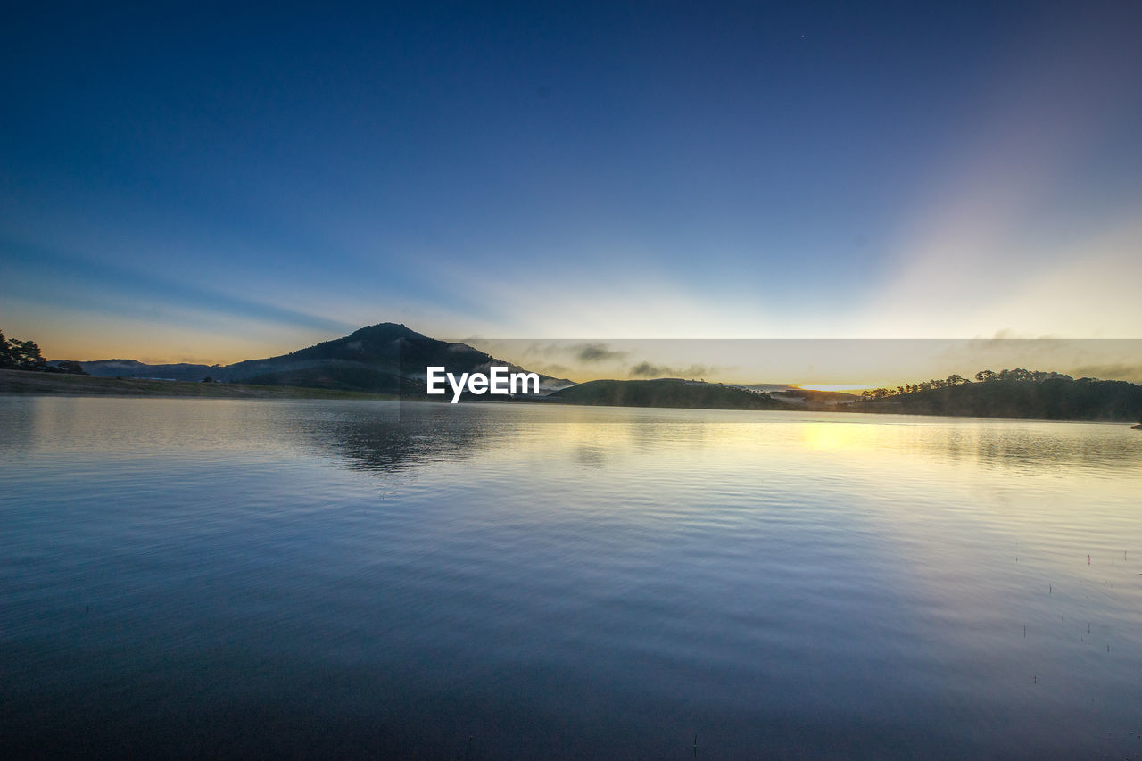 SCENIC VIEW OF LAKE BY MOUNTAINS AGAINST SKY
