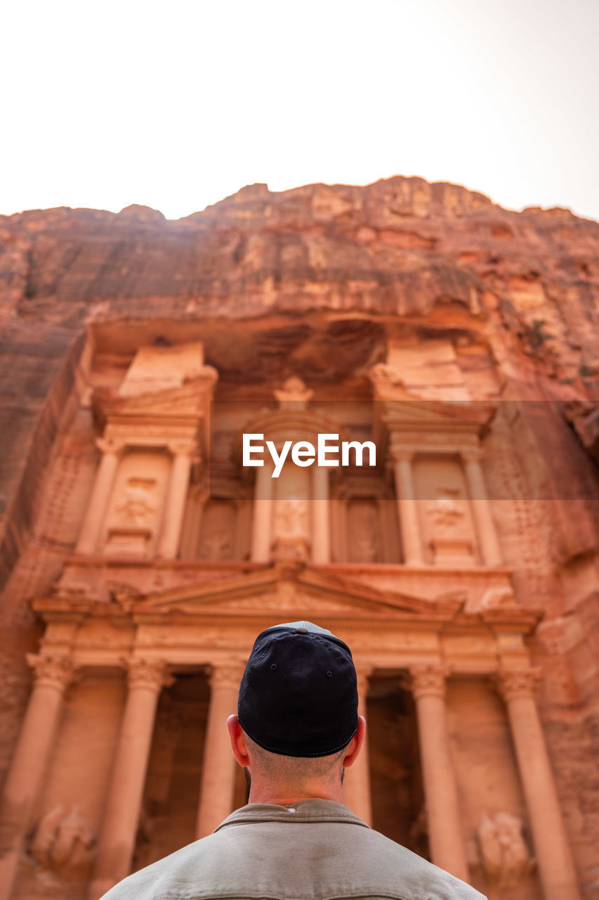 rear view of man standing against rock formations