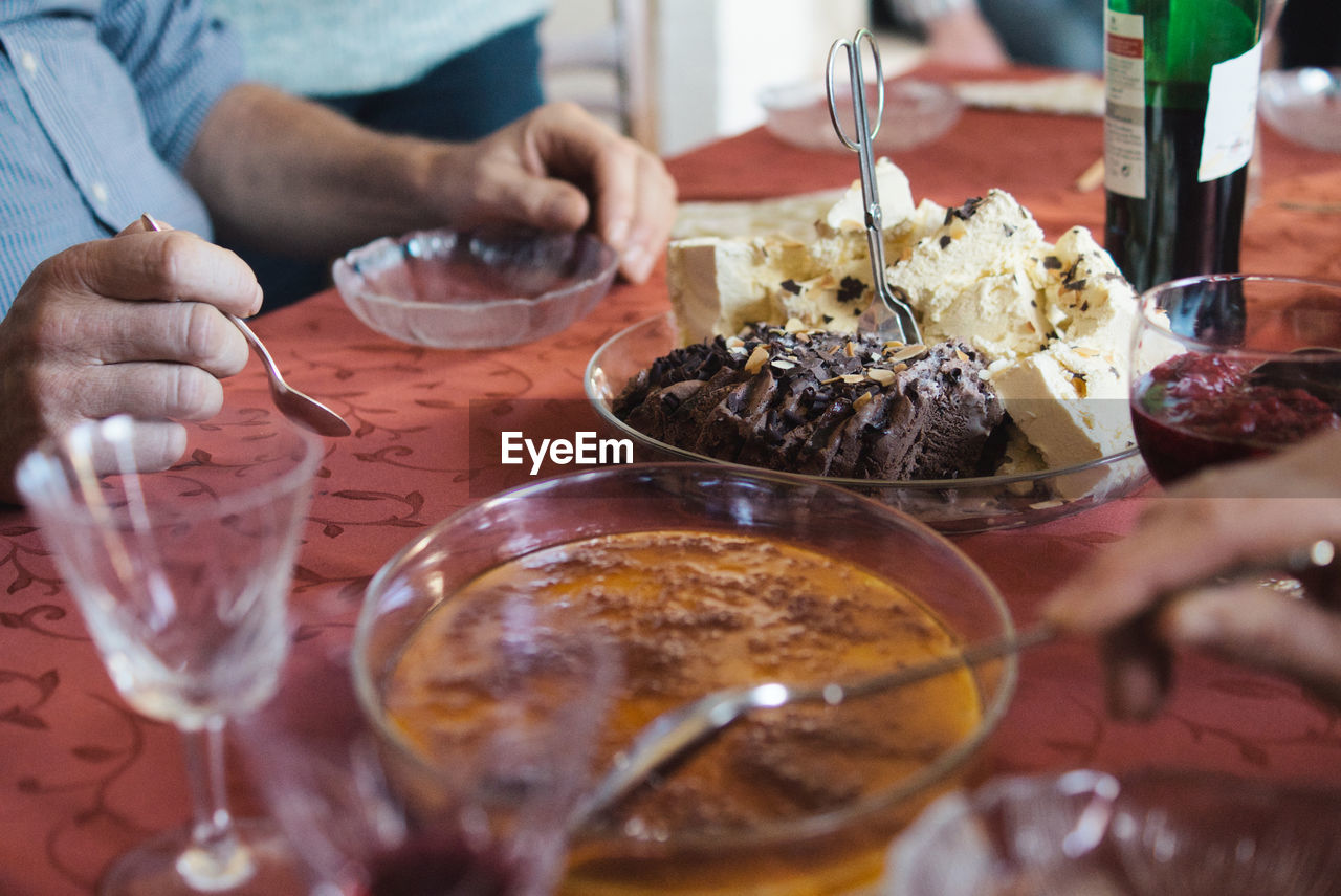 Midsection of man having food at table