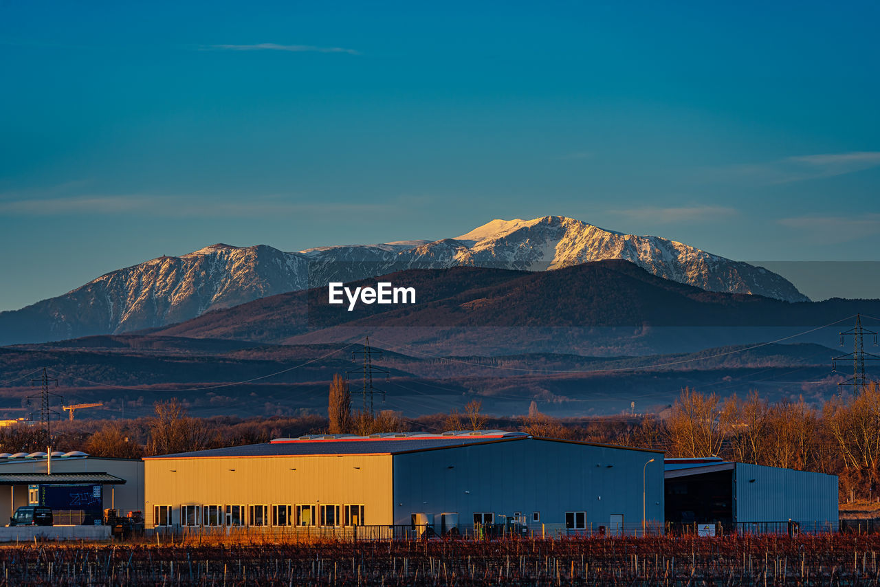 Industry bulding destroys the view to the snow mountain,