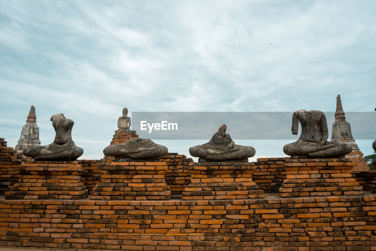 Statue of temple against cloudy sky