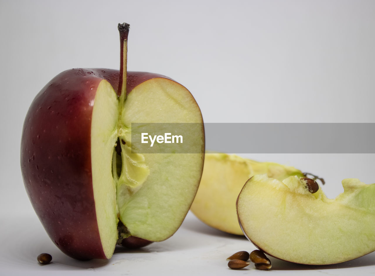 Close-up of apple on table against white background