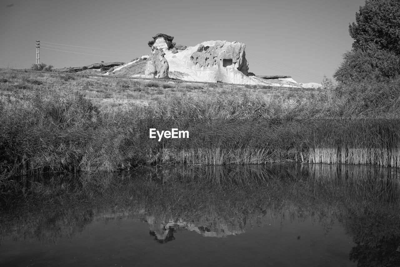 black and white, reflection, water, monochrome photography, monochrome, nature, plant, lake, tree, winter, snow, sky, white, environment, beauty in nature, landscape, scenics - nature, tranquility, no people, land, mountain, tranquil scene, day, outdoors, non-urban scene, darkness