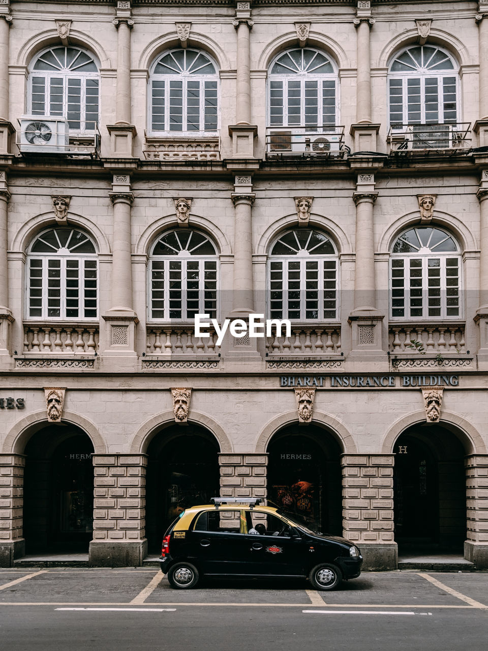 Cars on road by buildings in city