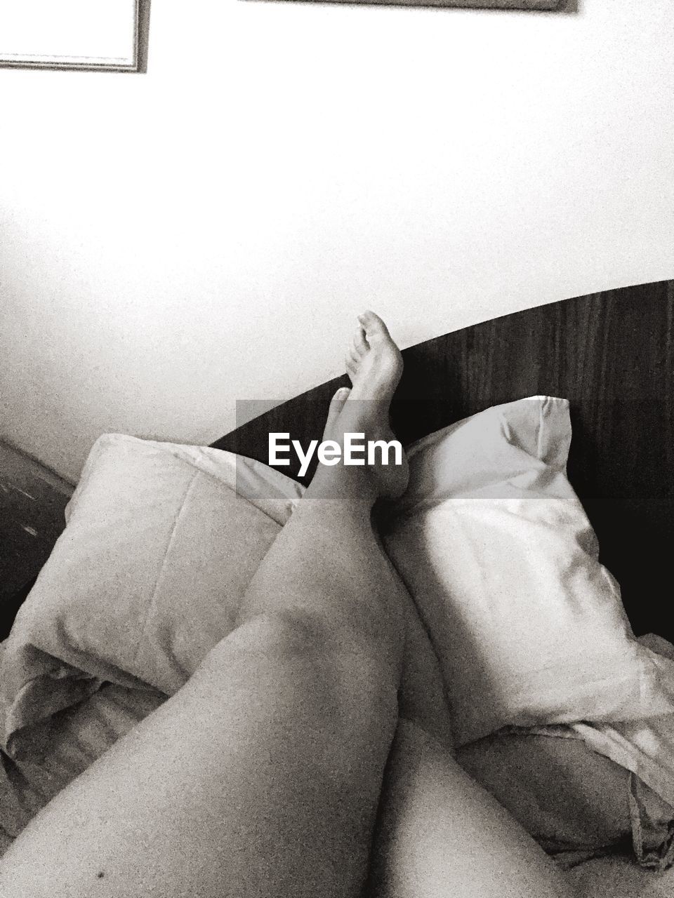 LOW SECTION OF WOMAN ON BED