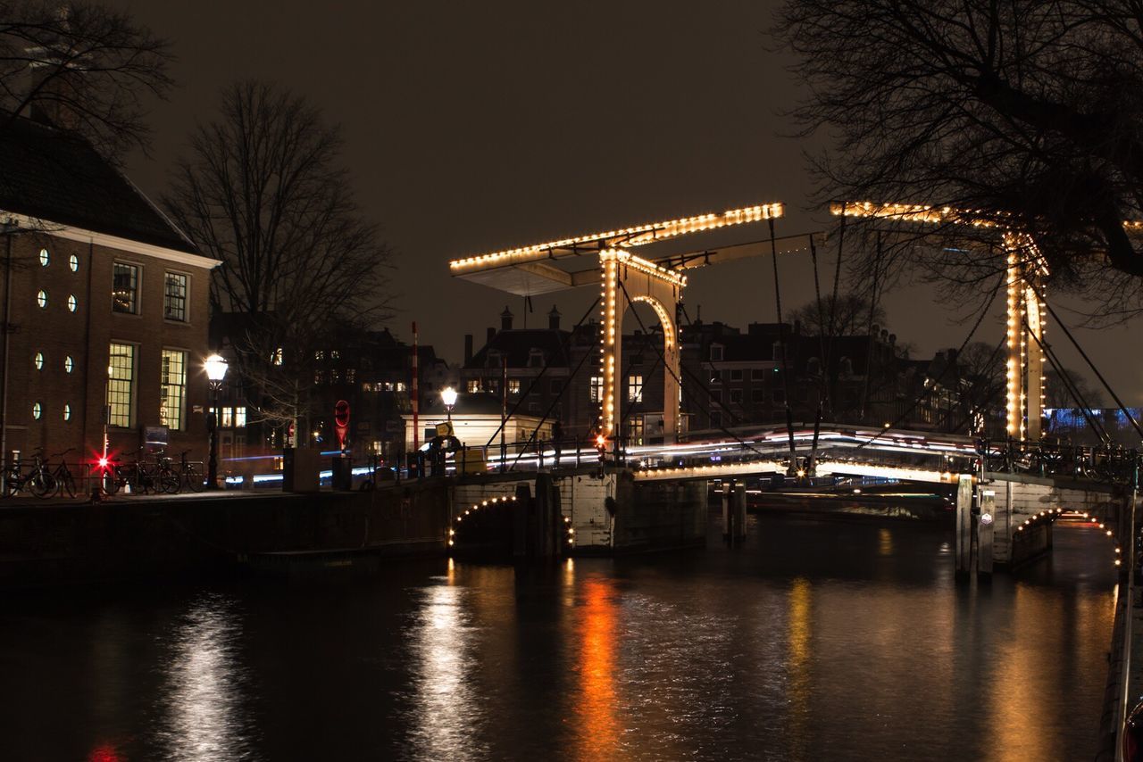 ILLUMINATED CITY AT WATERFRONT