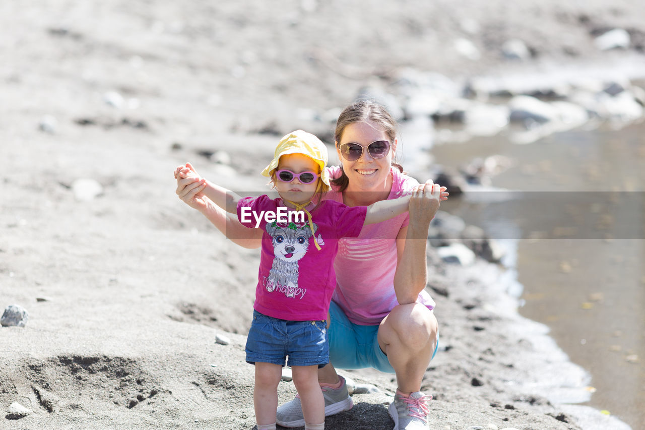 Full length of a girl wearing sunglasses on beach