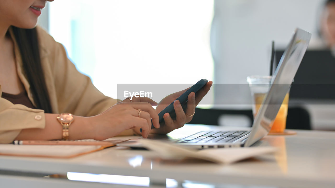 Midsection of woman working at office