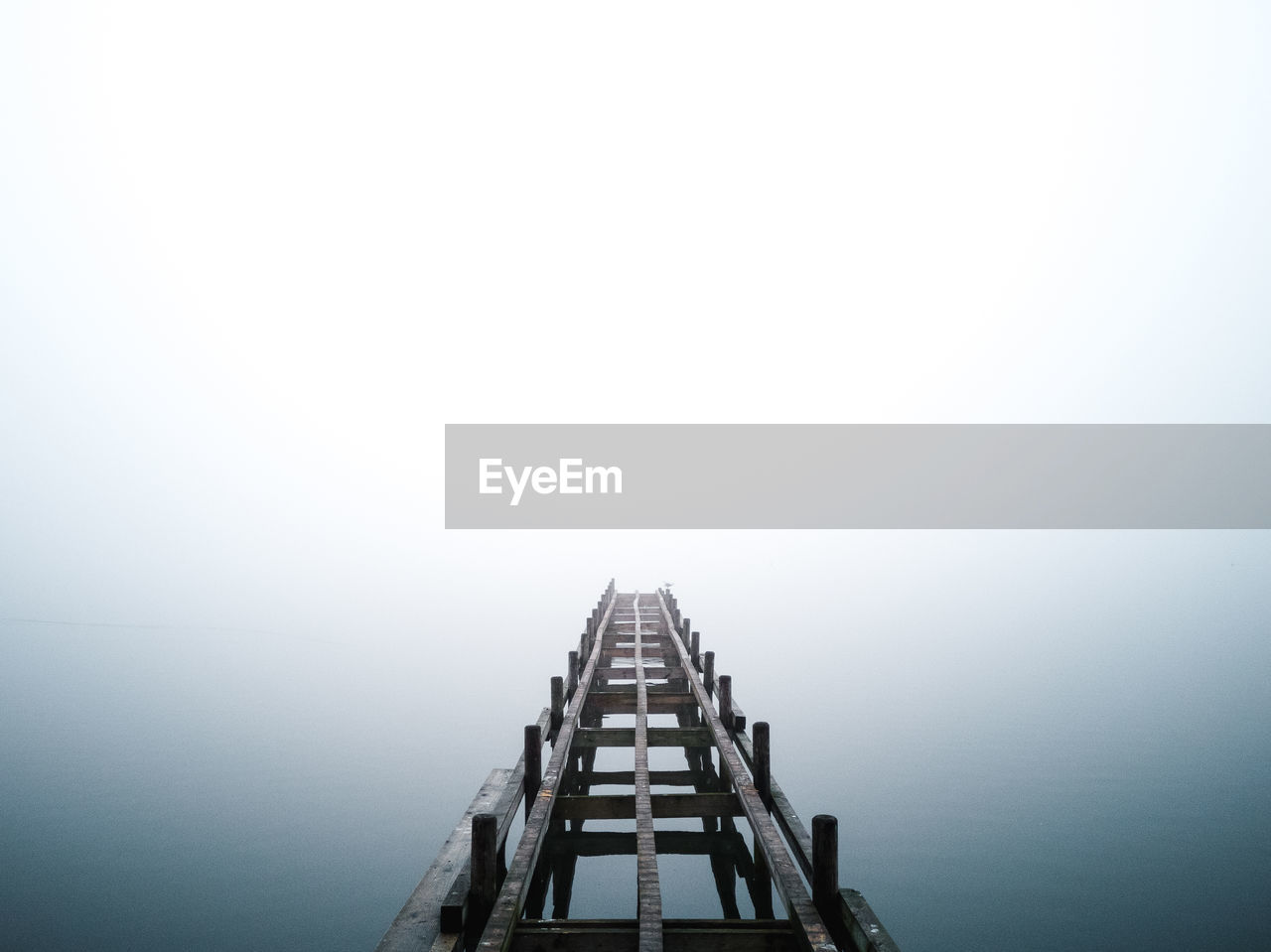 High angle view of pier on lake against sky