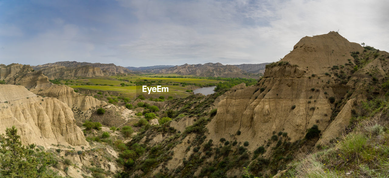 panoramic view of rocky mountains against sky