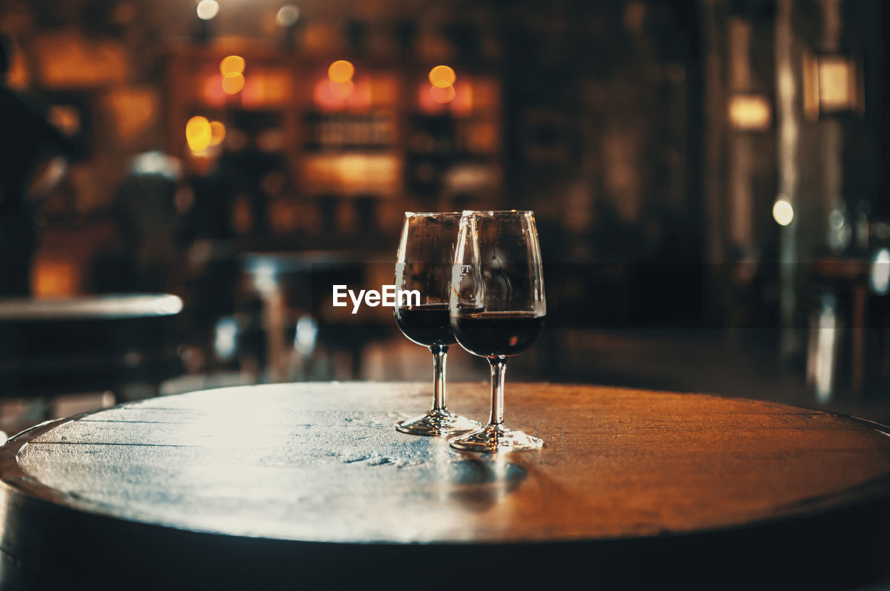 Close-up of alcoholic drinks served on wooden table in restaurant