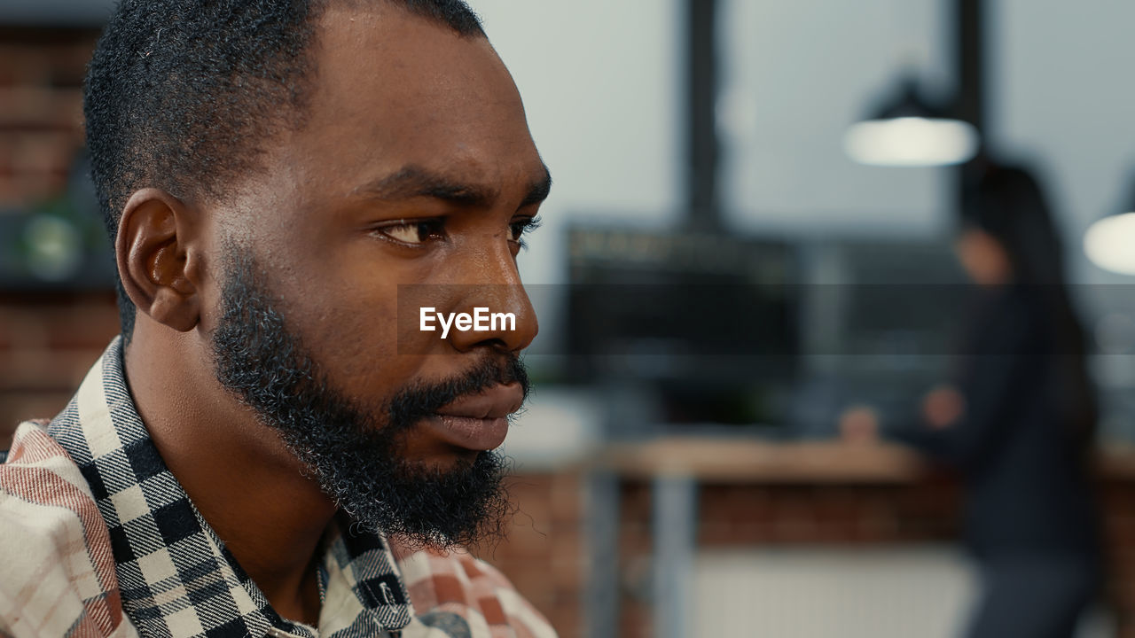 Close-up of businessman looking away at office