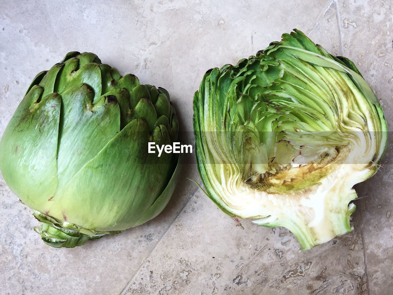 High angle view of halved artichoke on table