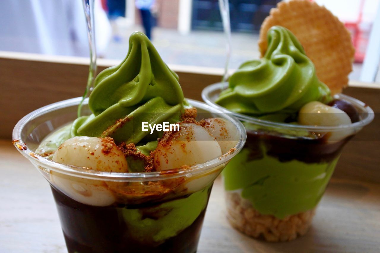 Close-up of green tea ice creams on wooden table