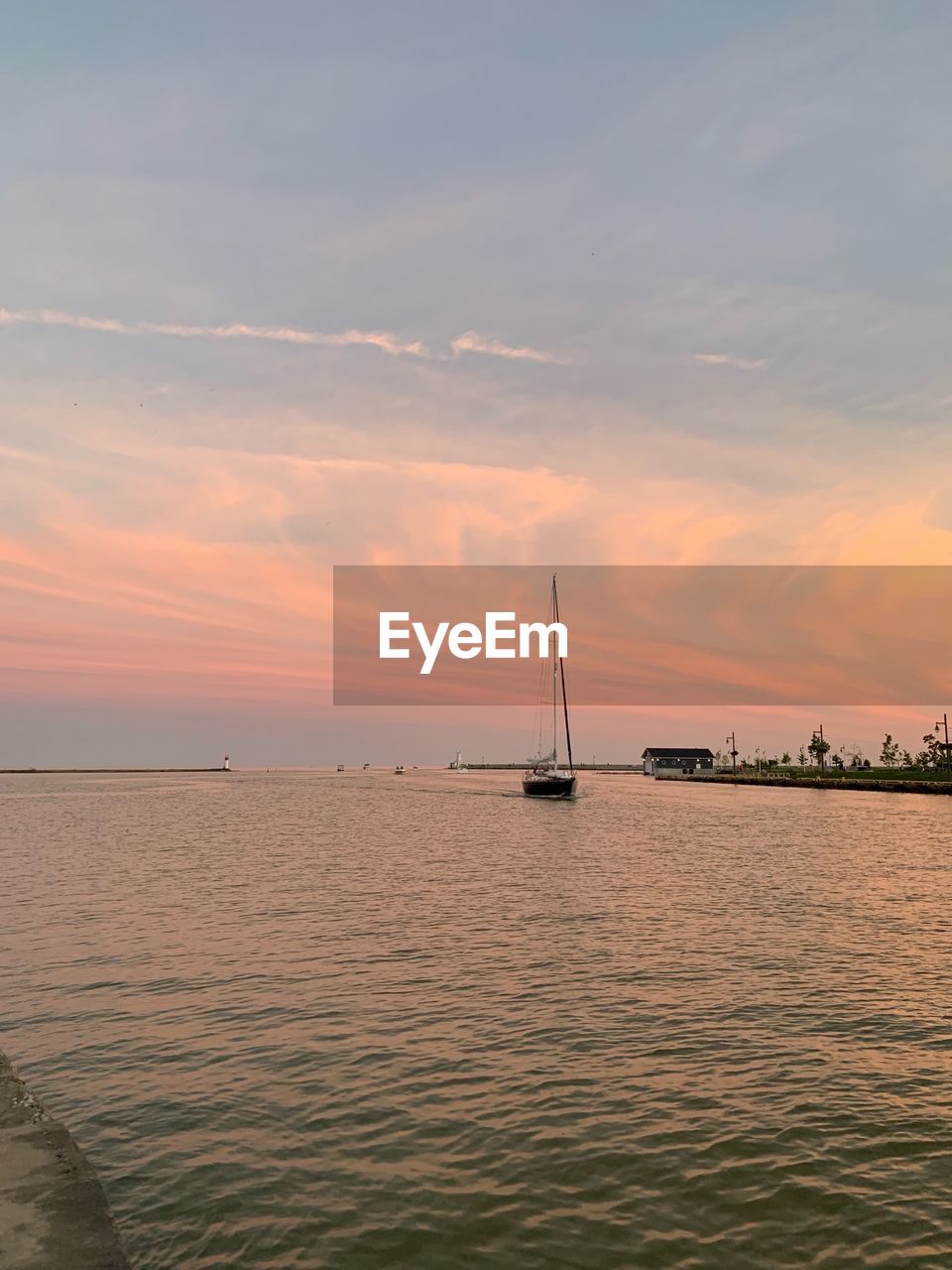 SAILBOAT ON SEA AGAINST SKY DURING SUNSET