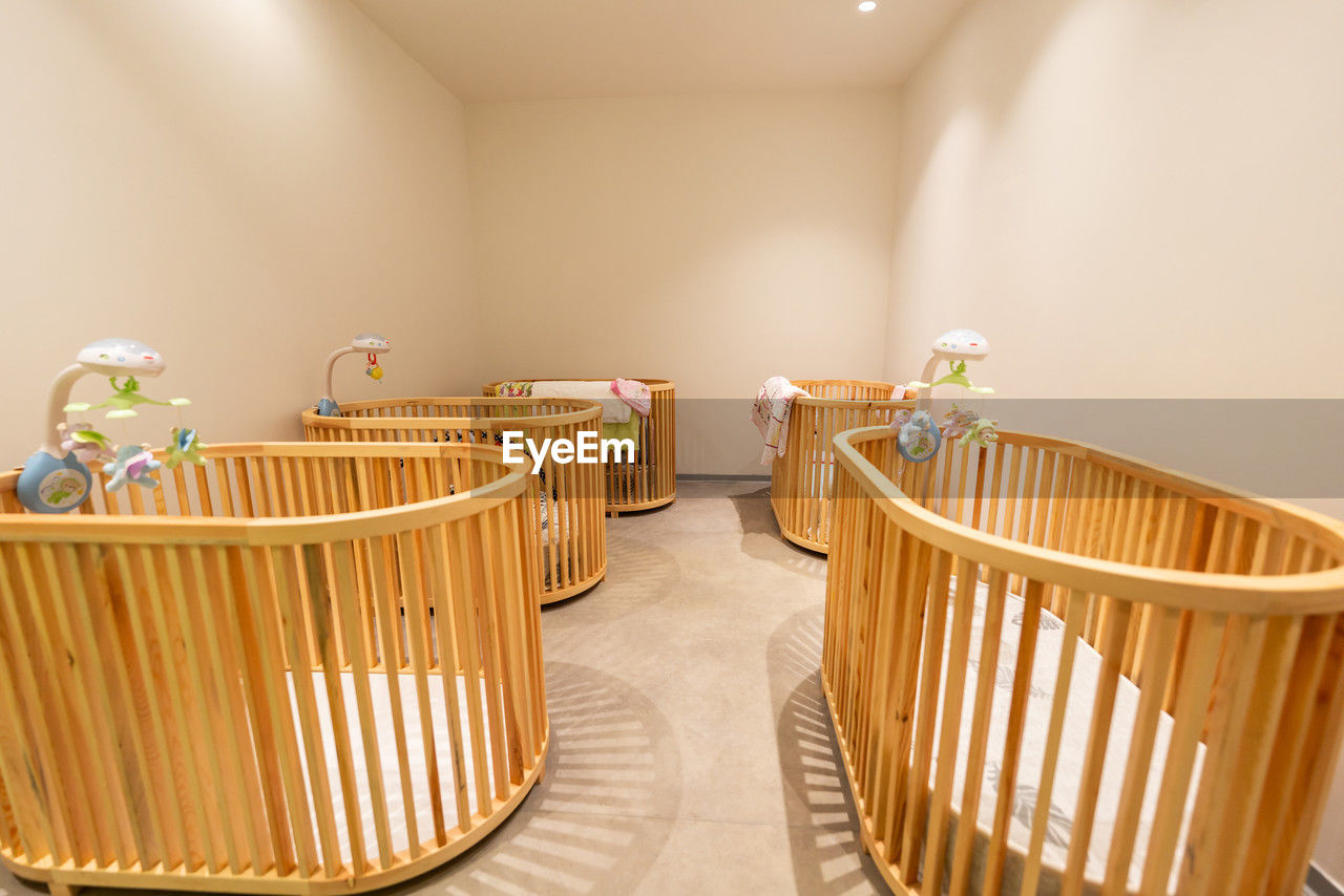 room, indoors, infant bed, domestic room, home interior, furniture, no people, architecture, seat, home, chair, table