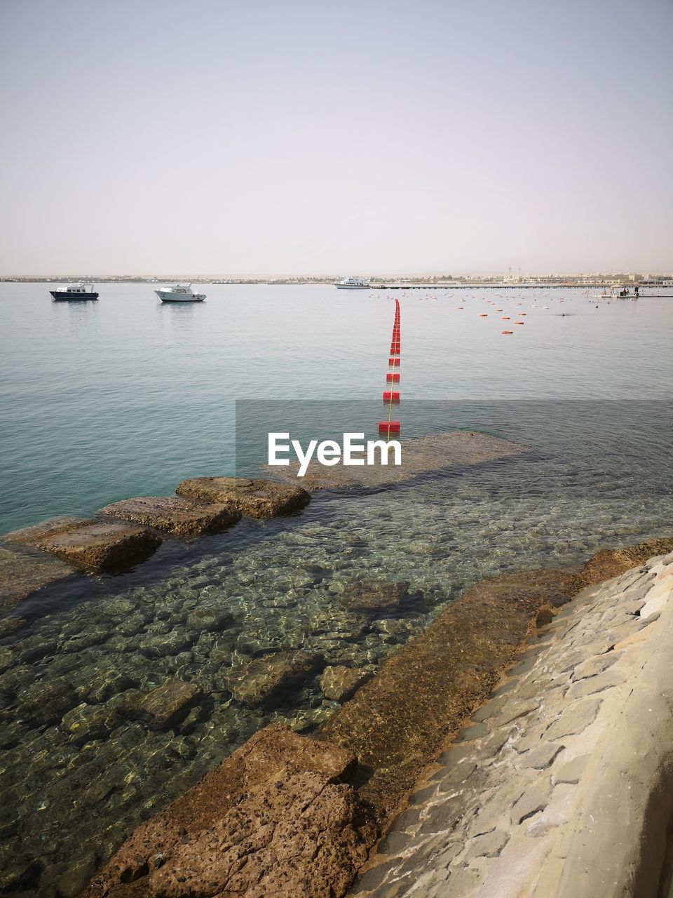 SAILBOATS ON SEA AGAINST CLEAR SKY