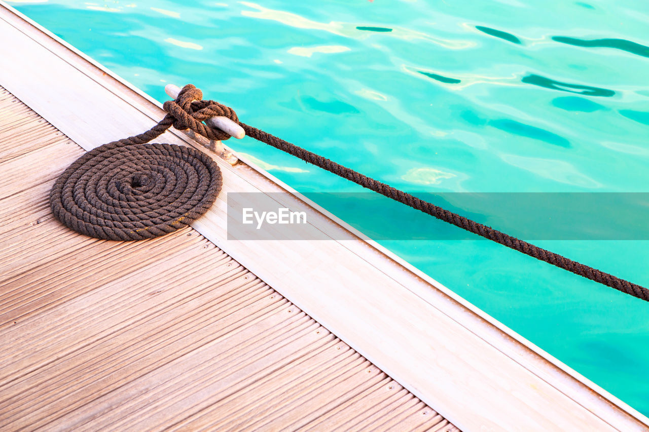 High angle view of rope tied on swimming pool
