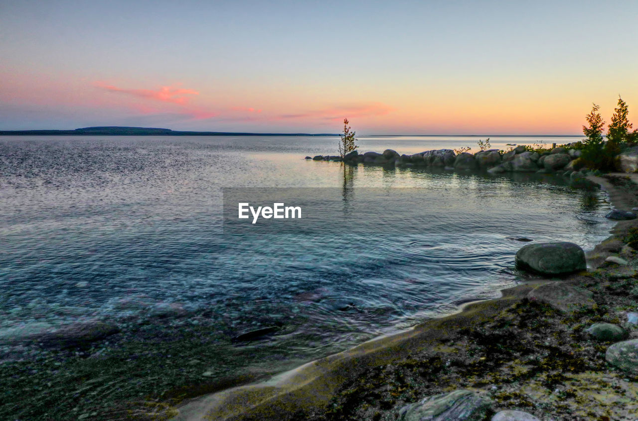 SCENIC VIEW OF SEA AGAINST ORANGE SKY