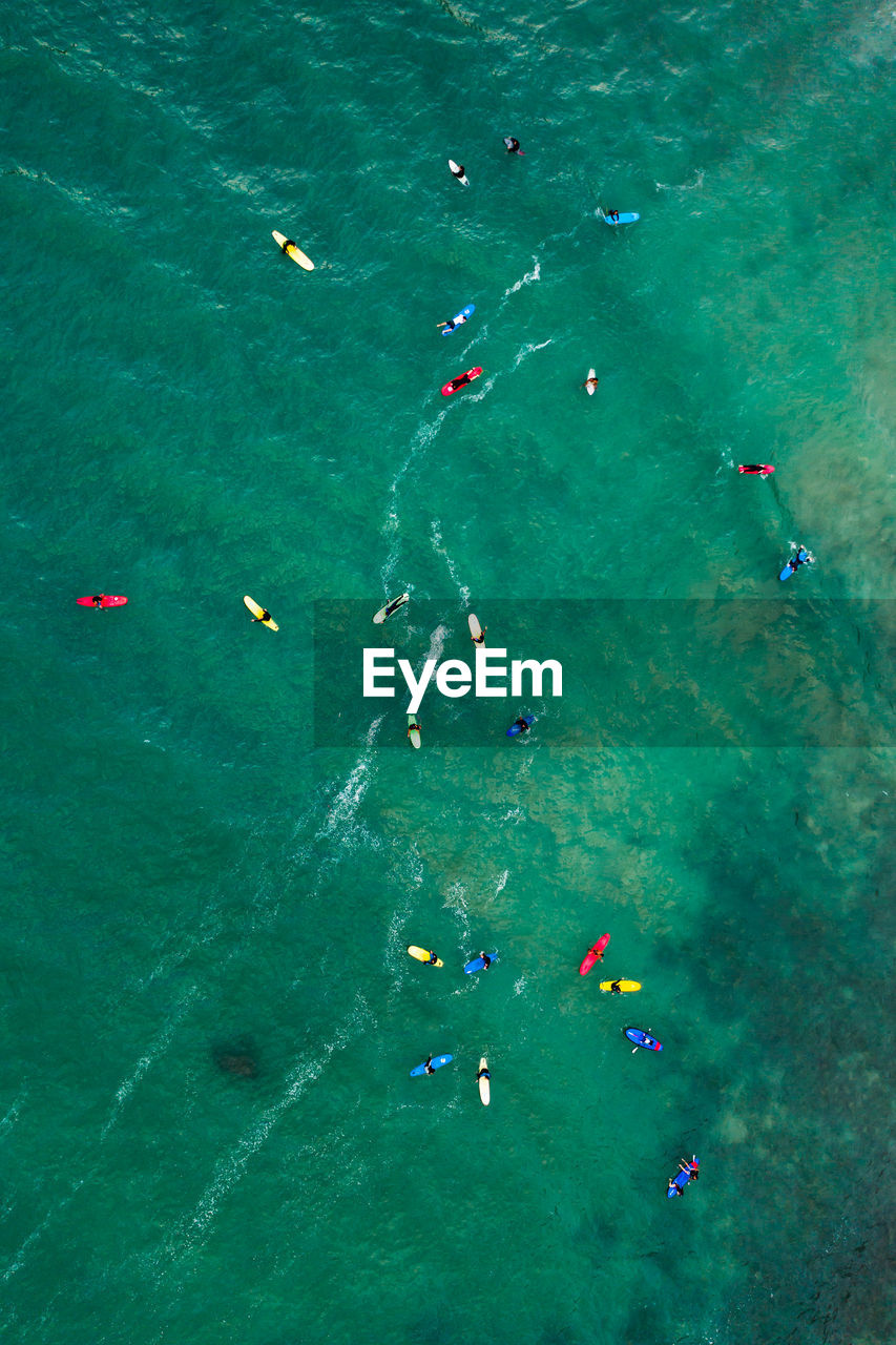 Aerial view of people surfing in sea