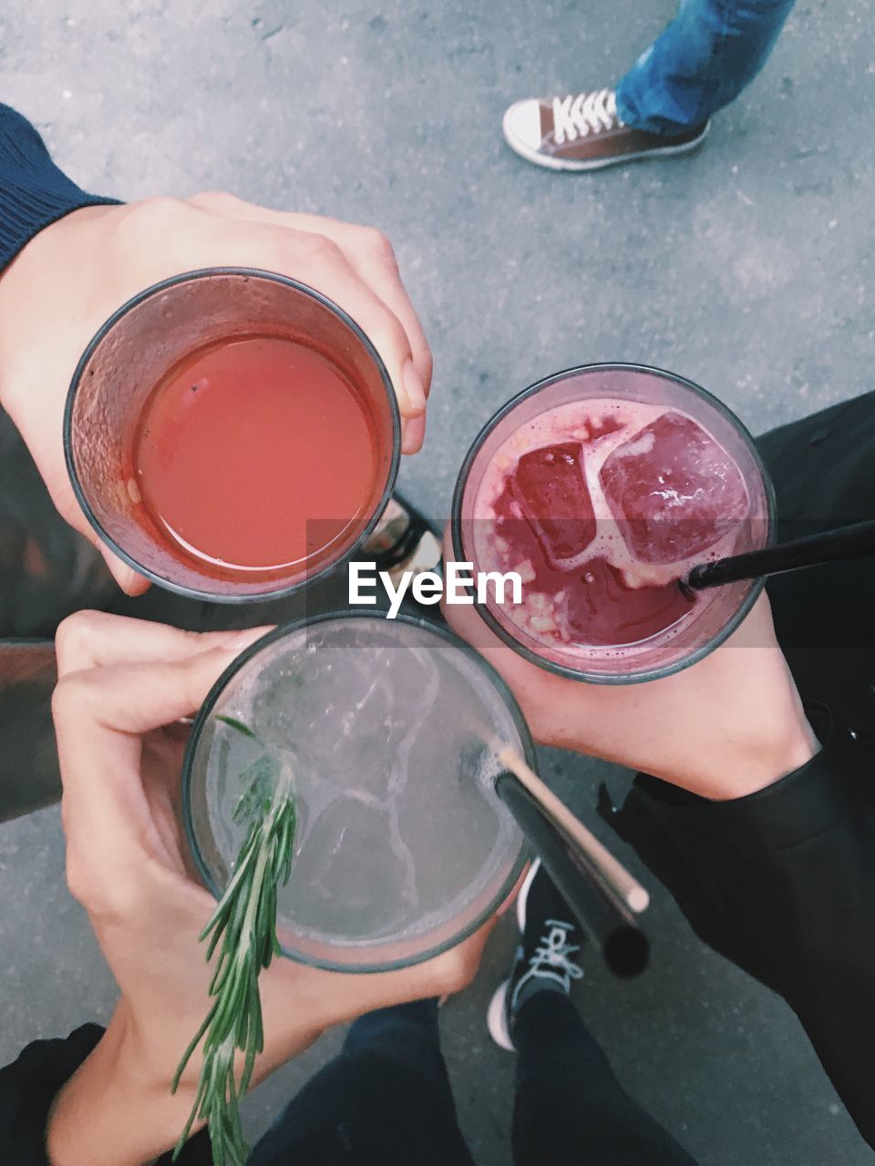 Cropped image of friends toasting cocktails outdoors