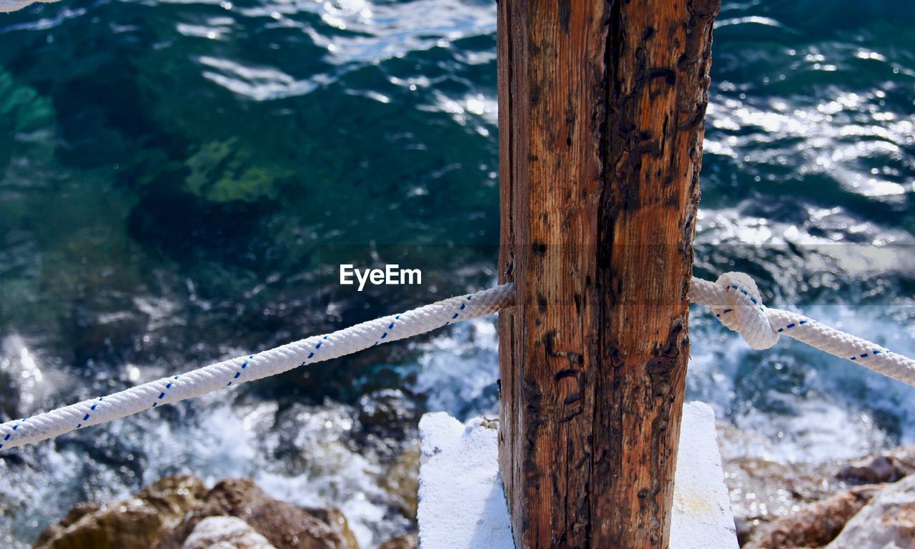 High angle view of wooden post in water