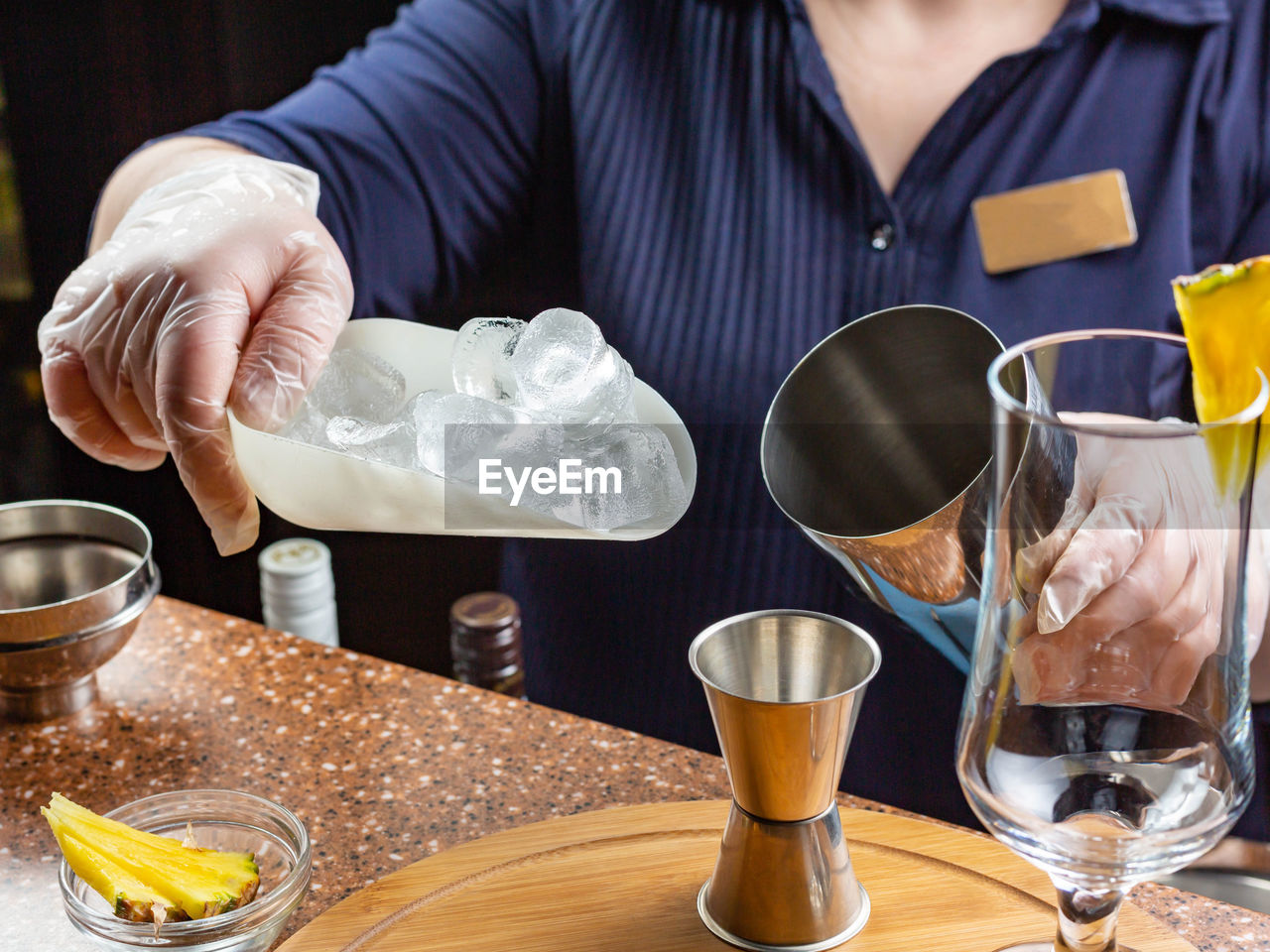 MIDSECTION OF WOMAN HOLDING GLASS OF WINE GLASSES