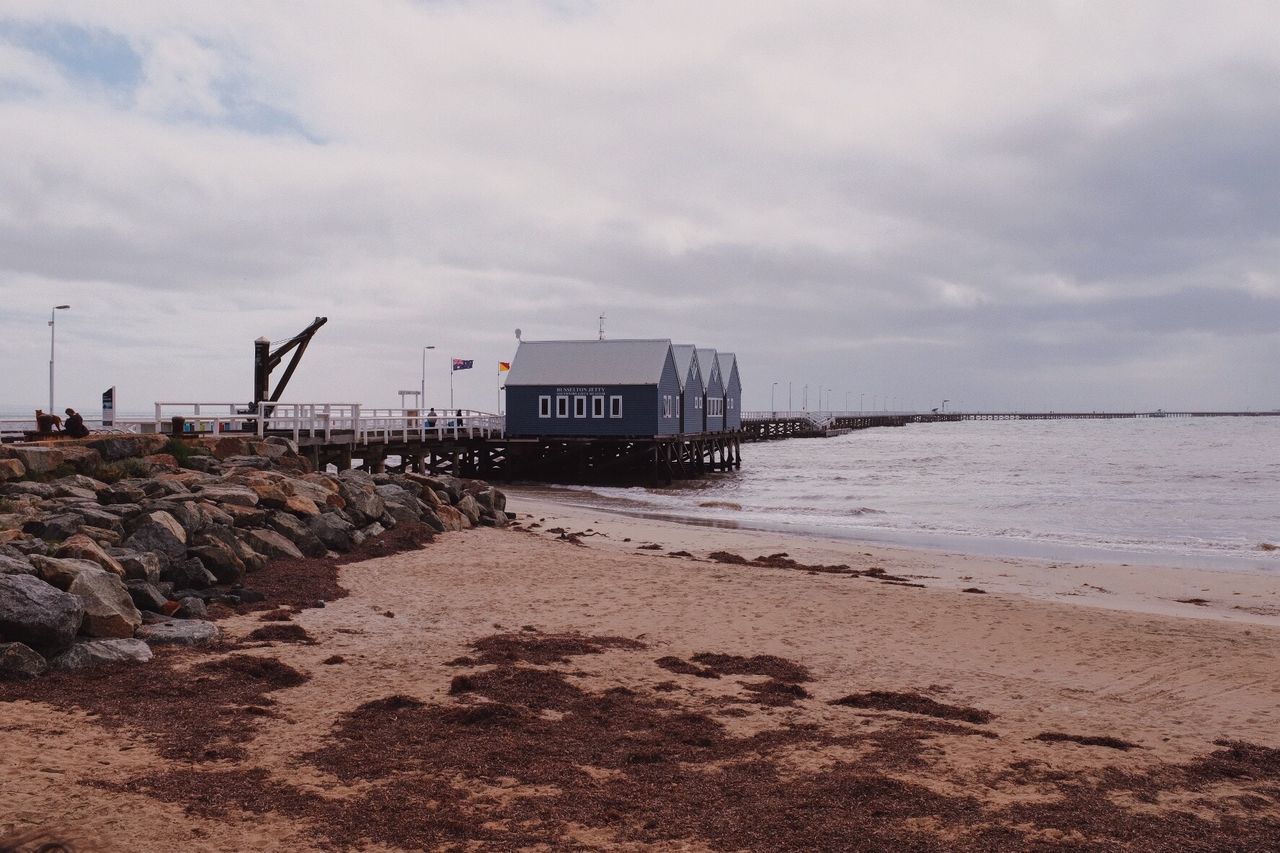 Huts on beach against clear sky