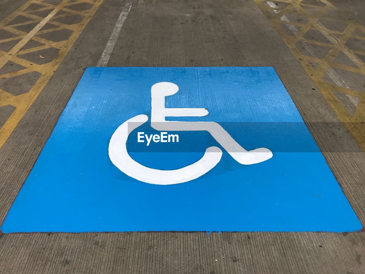 High angle view of disabled access sign at parking lot