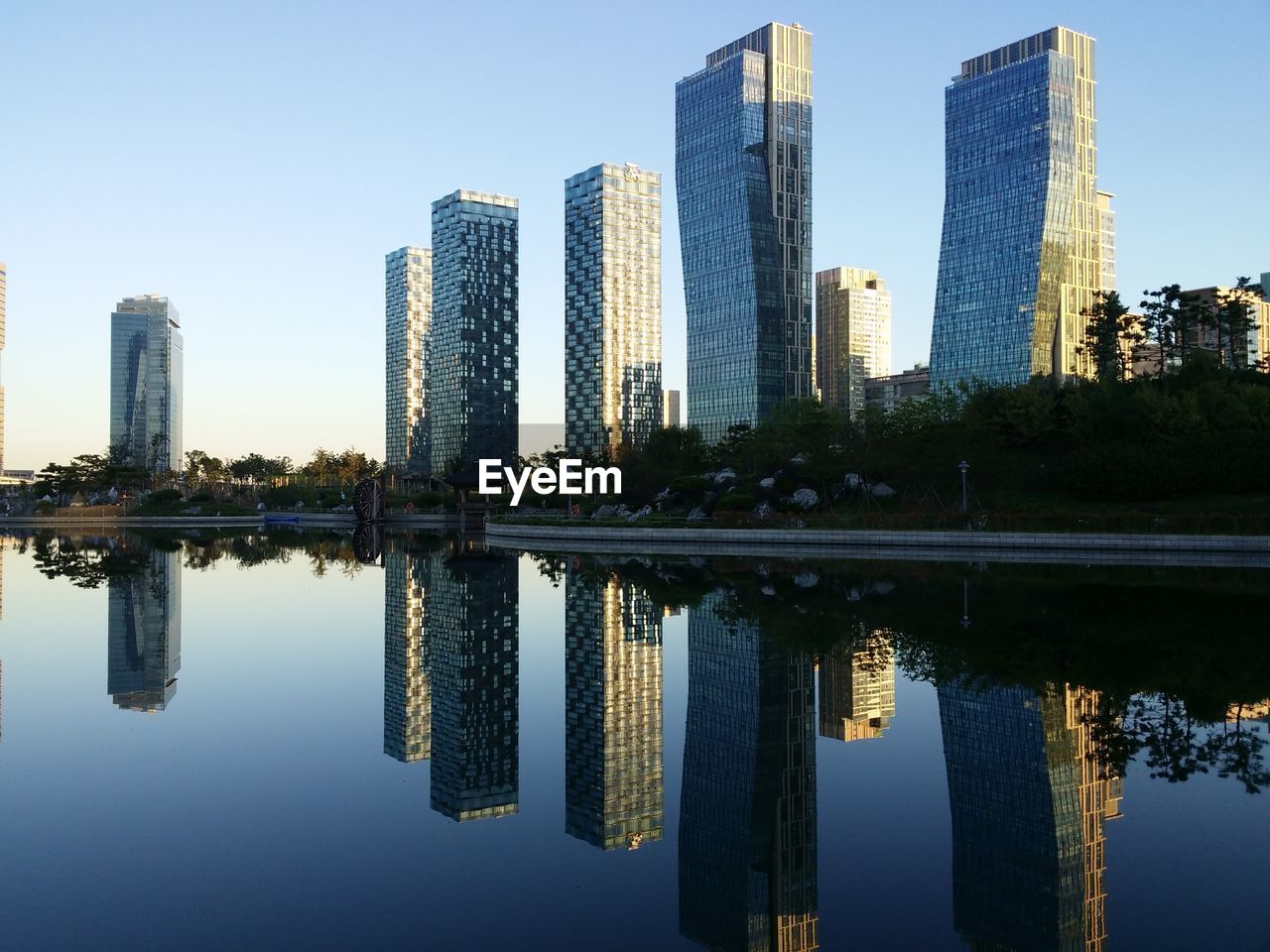 Reflection of buildings in river against sky