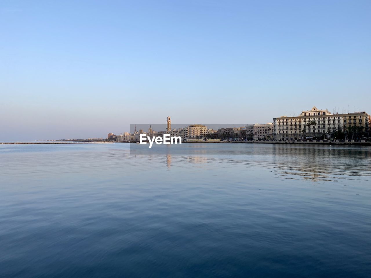 Scenic view of city bari against clear sky and sea