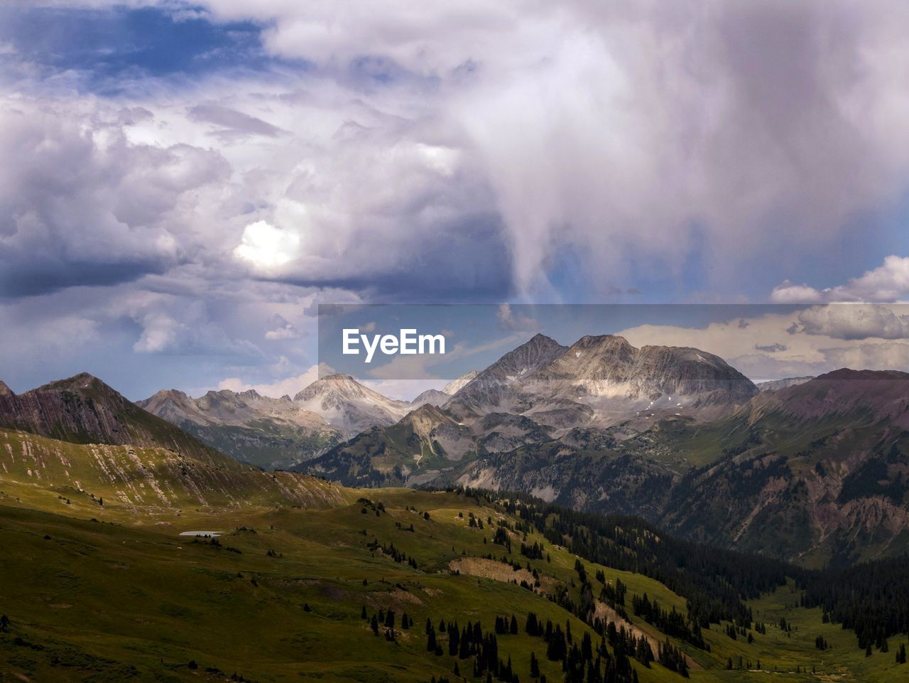 Scenic view of mountains against cloudy sky