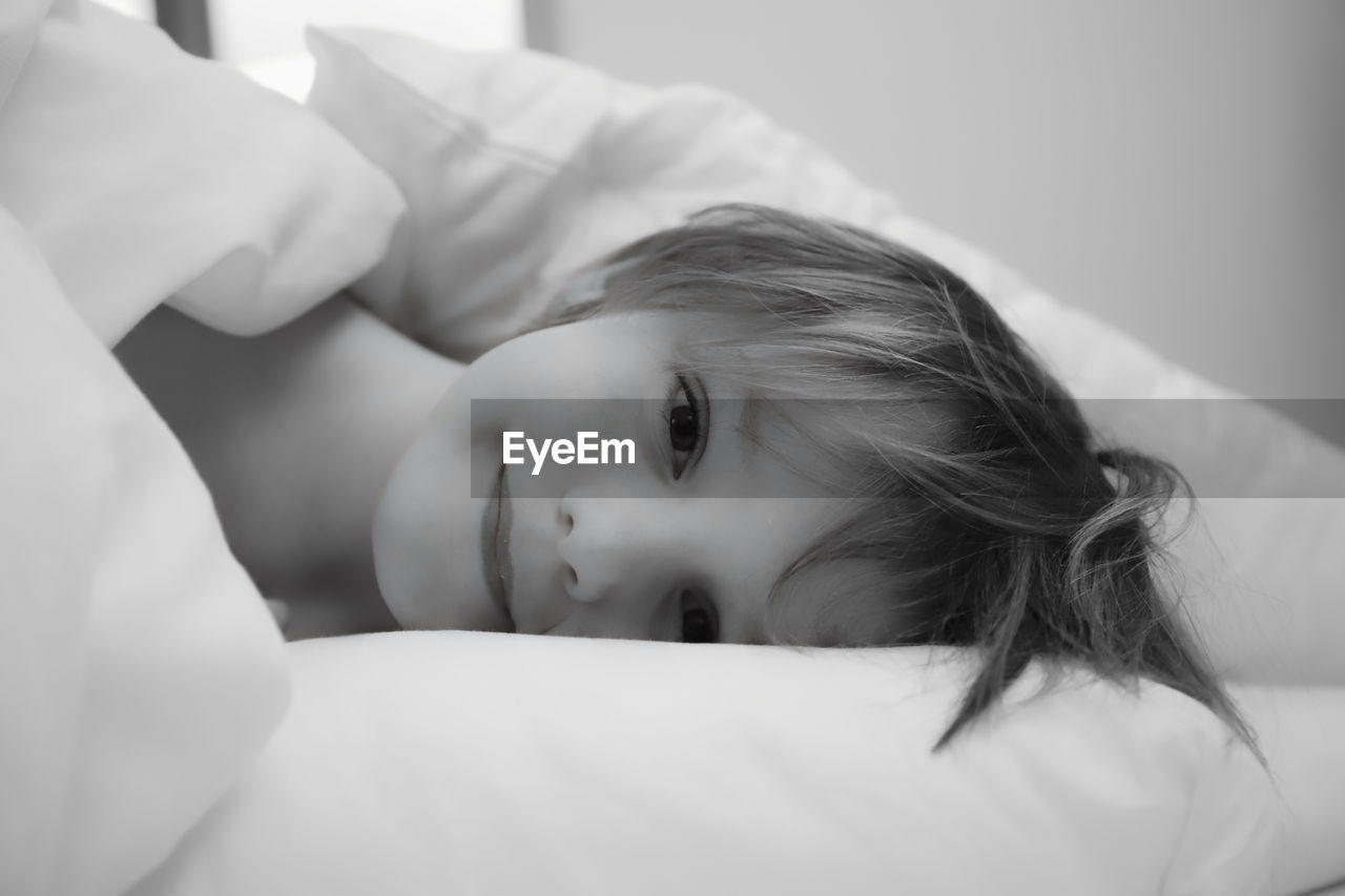 Portrait of boy relaxing on bed at home