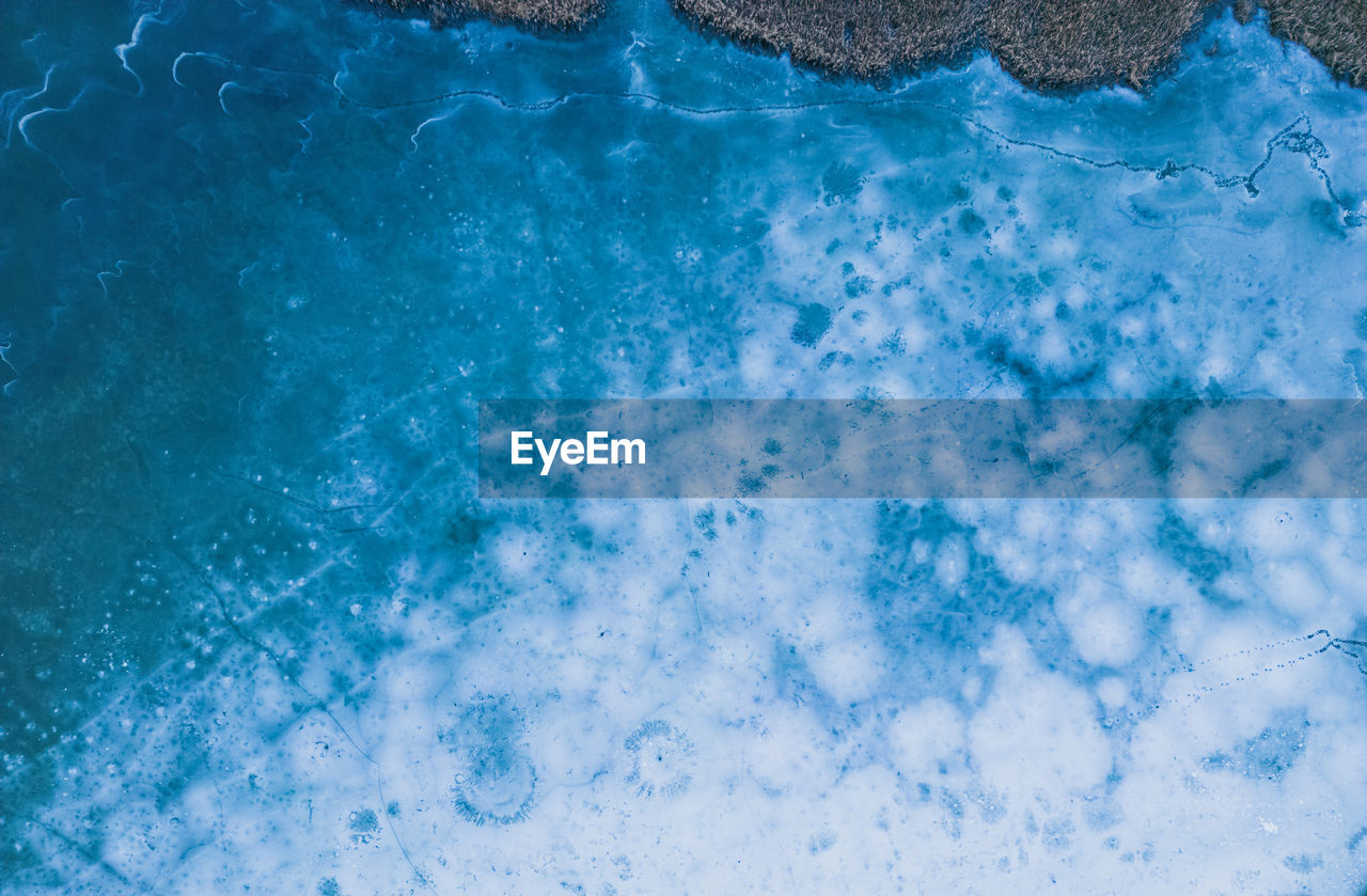 Aerial view of a frozen lake. ice sheet background. frozen waves on the lake. ice background. 