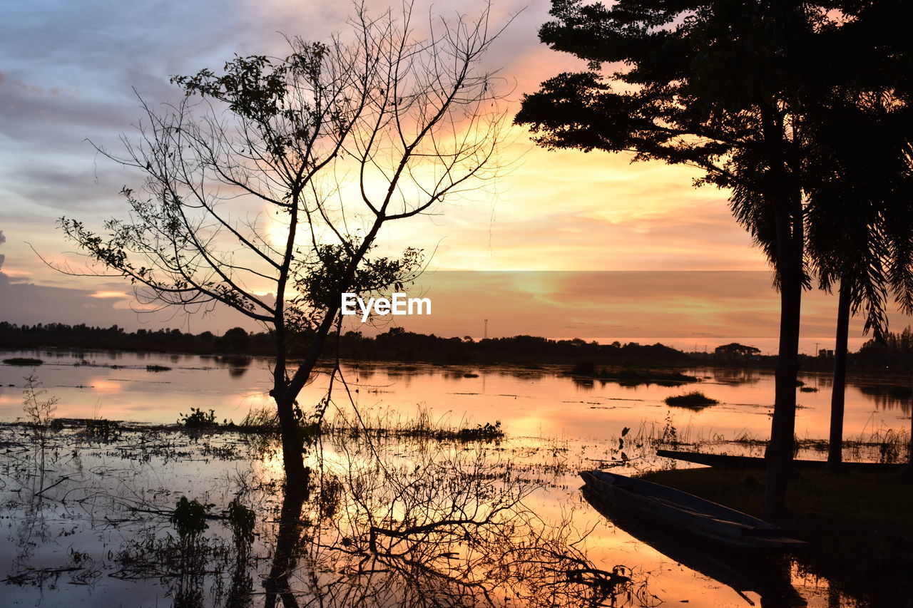 SCENIC VIEW OF LAKE AGAINST ORANGE SKY