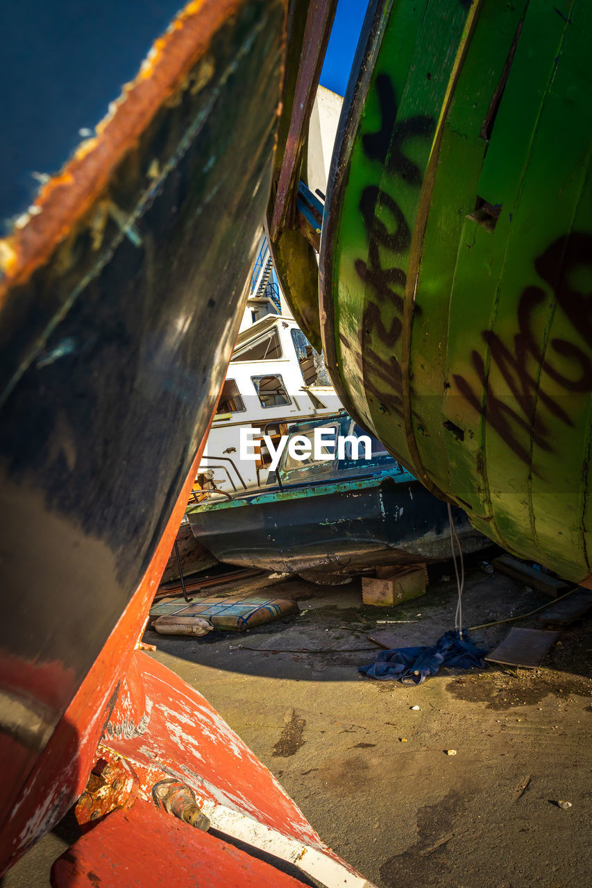 CLOSE-UP OF ABANDONED BOAT MOORED ON SHORE